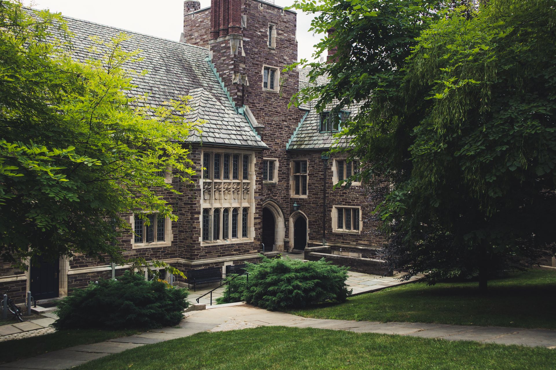 Historic Gothic university campus building surrounded by trees